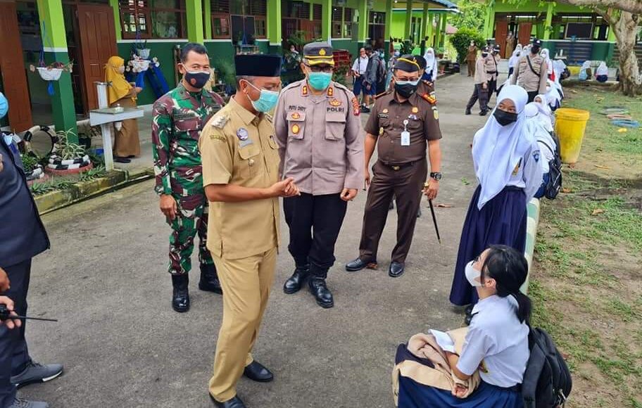 TINJAU: Bupati Sukamara H Windu Subagio bersama unsur forkopimda berbincang dengan pelajar di sela-sela kegiatannya saat meninjau pelaksanaan PTM di sejumlah sekolah belum lama tadi./HUMAS