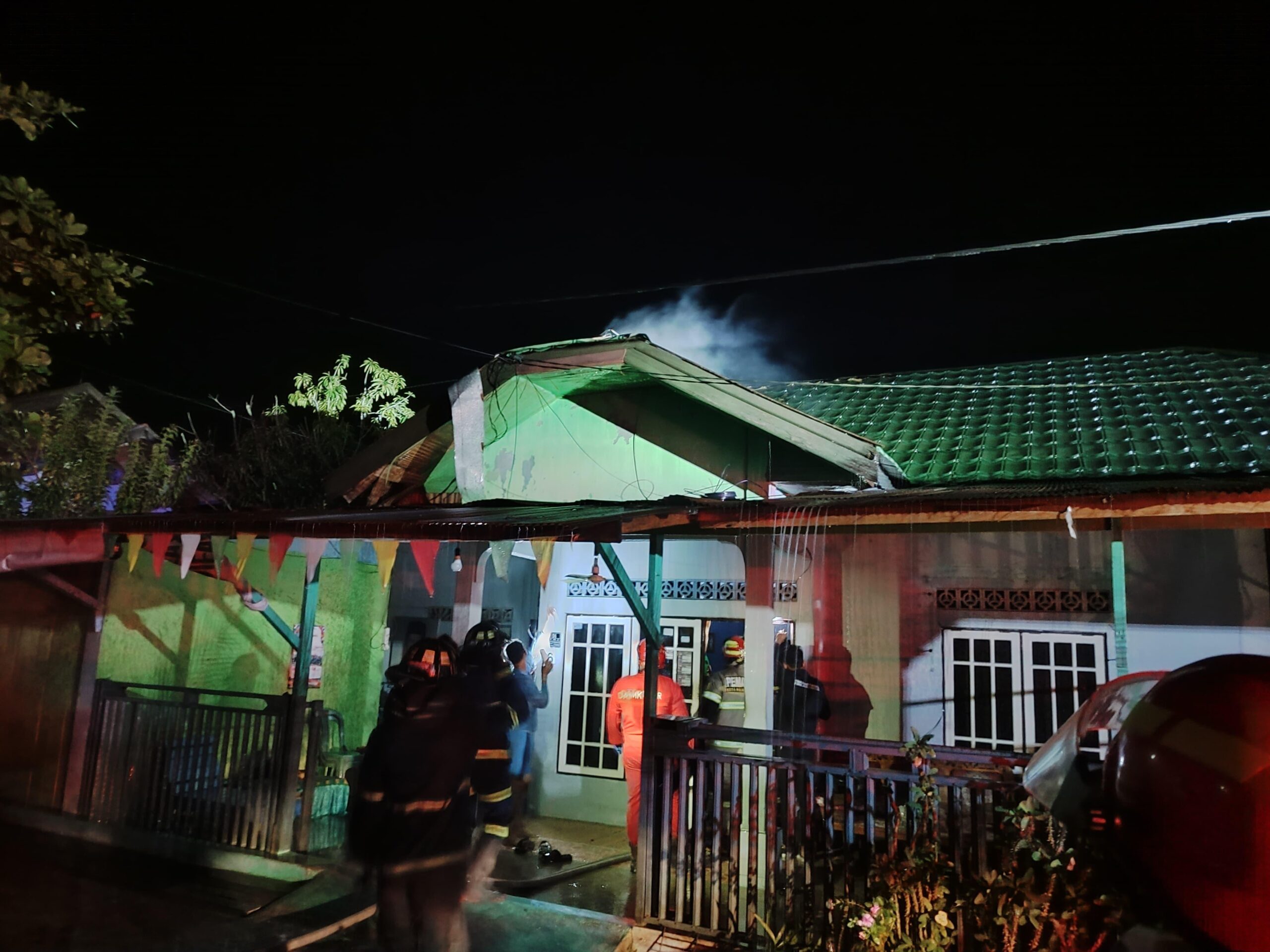 Petugas ketika memadamkan rumah