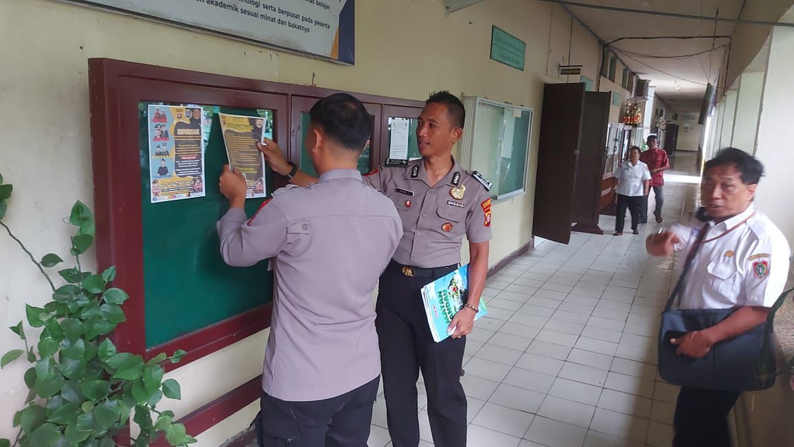 Personel kepolisian ketika mensosialisasikan rekrutmen polri TA 2026 ke sekolah di Palangka Raya