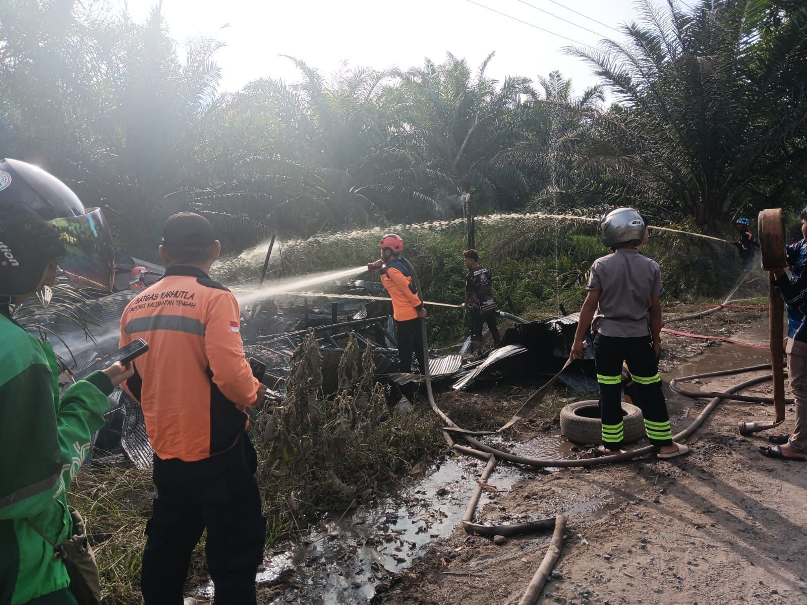 Petugas ketika melakukan pemadaman terhadap warung yang terbakar di wilayah Sabangau