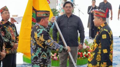 ‎Gubernur Kalteng, H. Agustiar Sabran saat menyerahkan bendera Pesparawi kepada Ketua Umum LPPD Kalteng, sekaligus Ketua Kontingen, Guntur Talajan, dalam acara